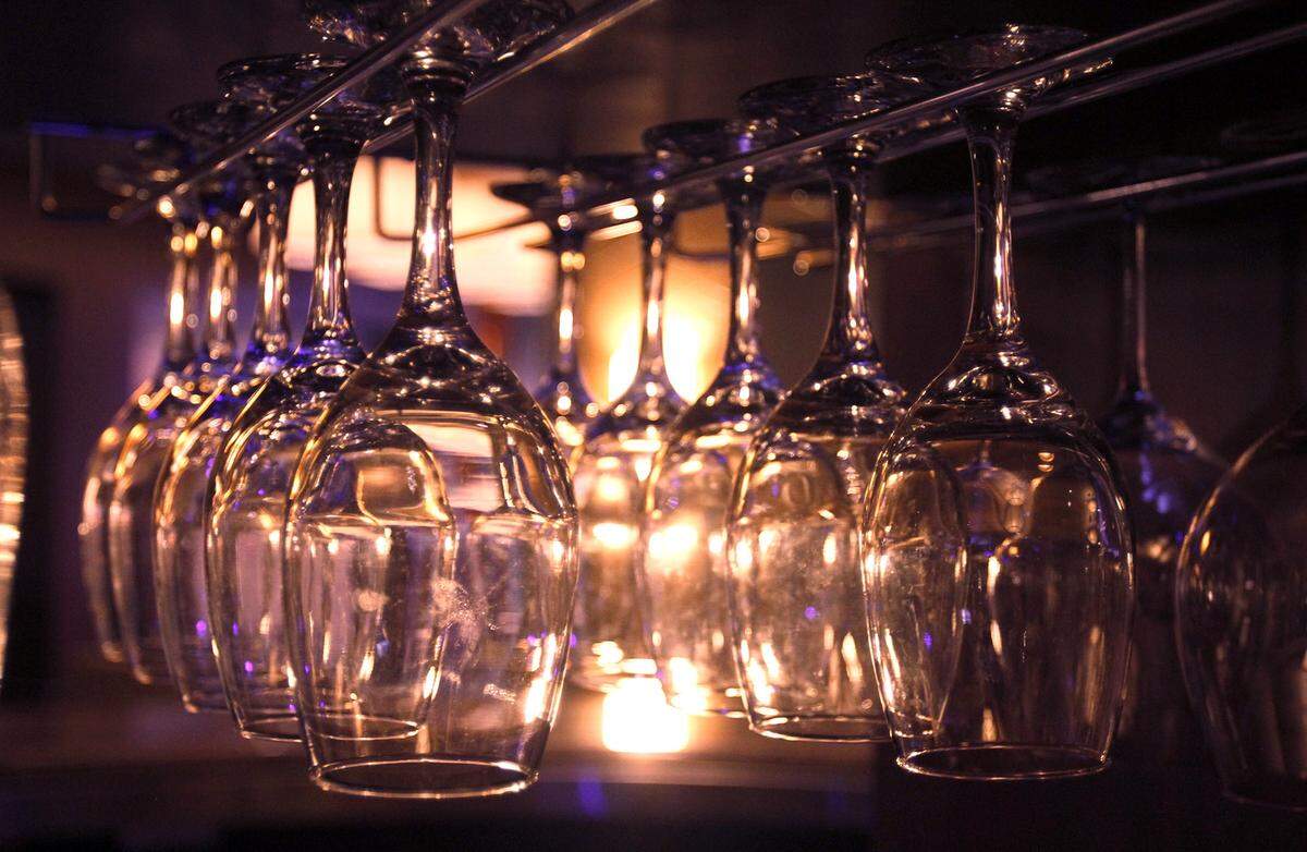Wine glasses hang in the bar at Mignon’s Steaks & Seafood in Biloxi, where Thanksgiving dinner will be a special treat.