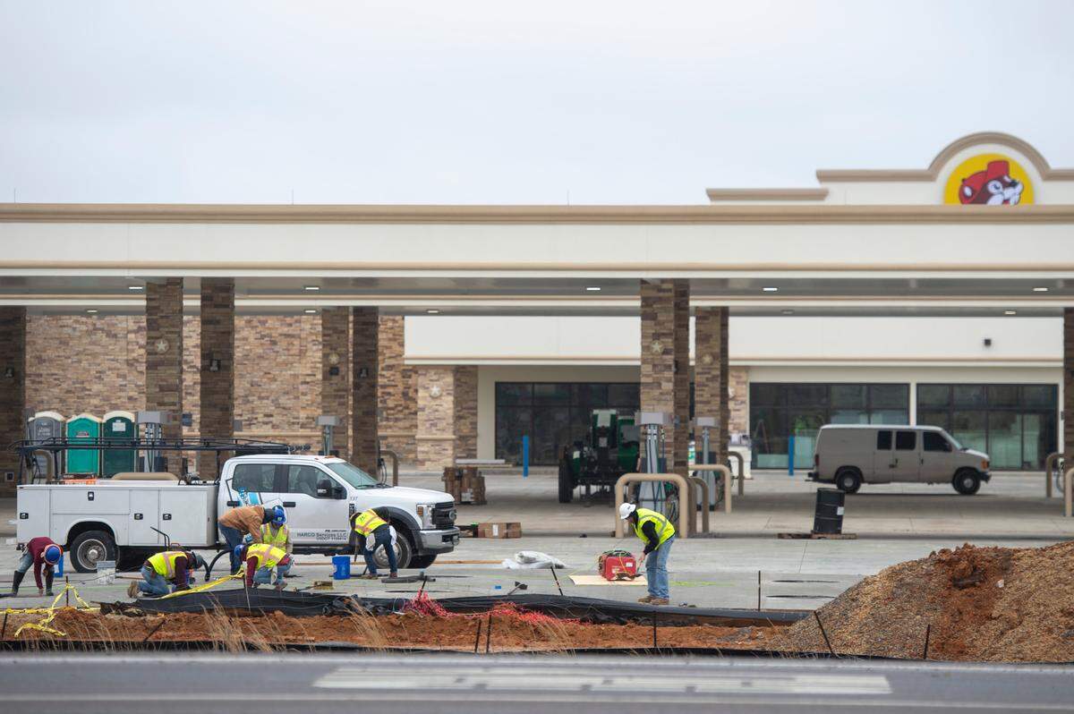 A smiling Buc-ee’s beaver mascot looks out from the building as crews work toward the grand opening of Buc-ee’s travel center in Harrison County.