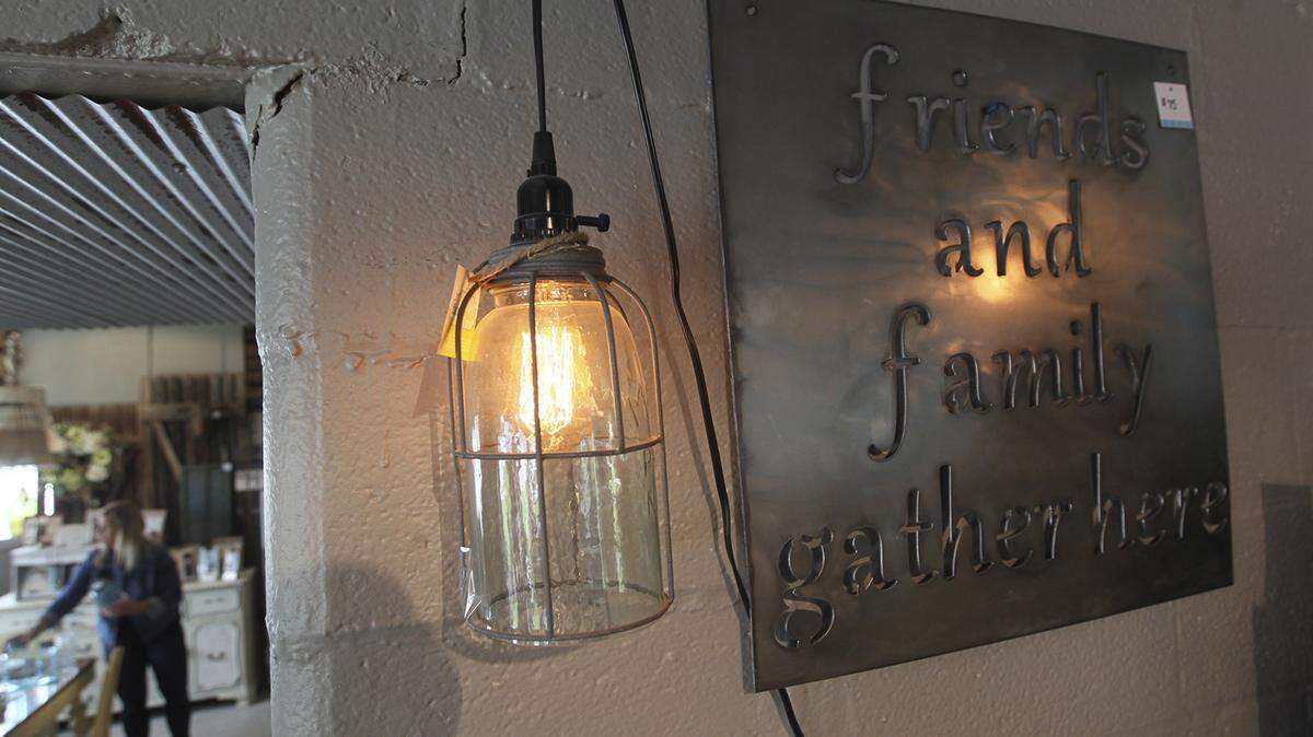 MICHAEL CHRITTON/AKRON BEACON JOURNAL/TNSA large canning jar at the Funky Junk Boutique makes a rustic light fixture. The bottom is cut out of the jar for globe-style outdoor lighting.