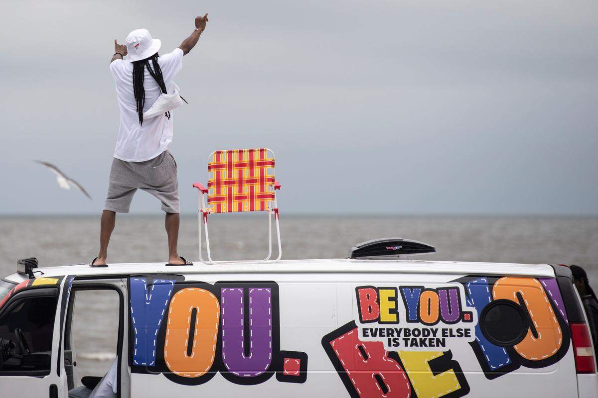 A spring breaker dances on top of a van during Black Spring Break at Biloxi Beach last year.