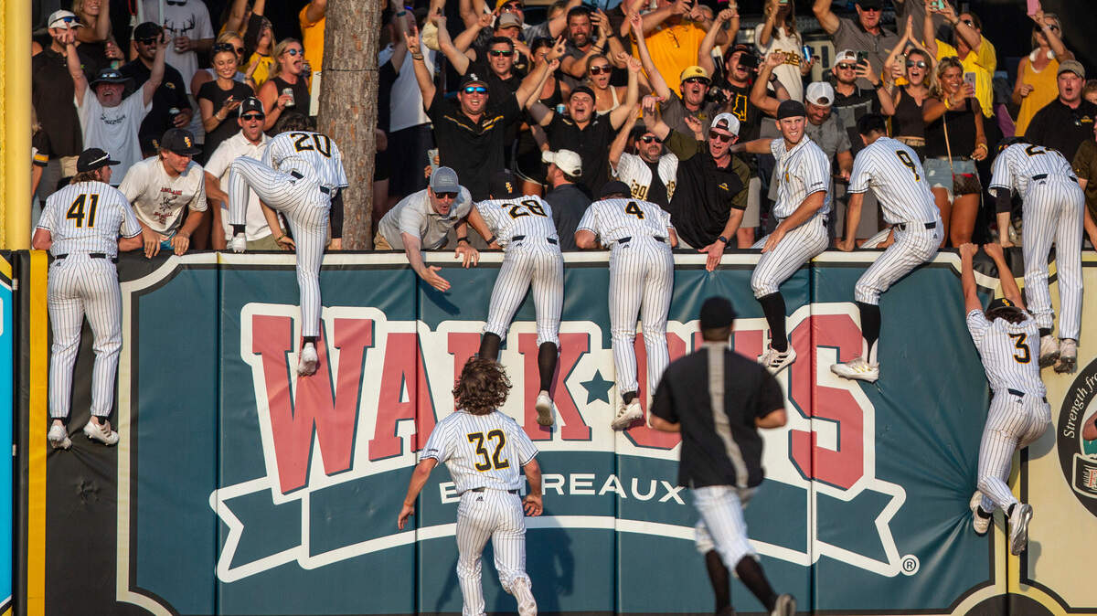 Southern Miss players climb over the right field wall to the roost after defeating LSU 8-7 in the NCAA Regionals at Pete Taylor Park in Hattiesburg on Monday, June 6, 2022. Southern Miss will advance to super regionals.