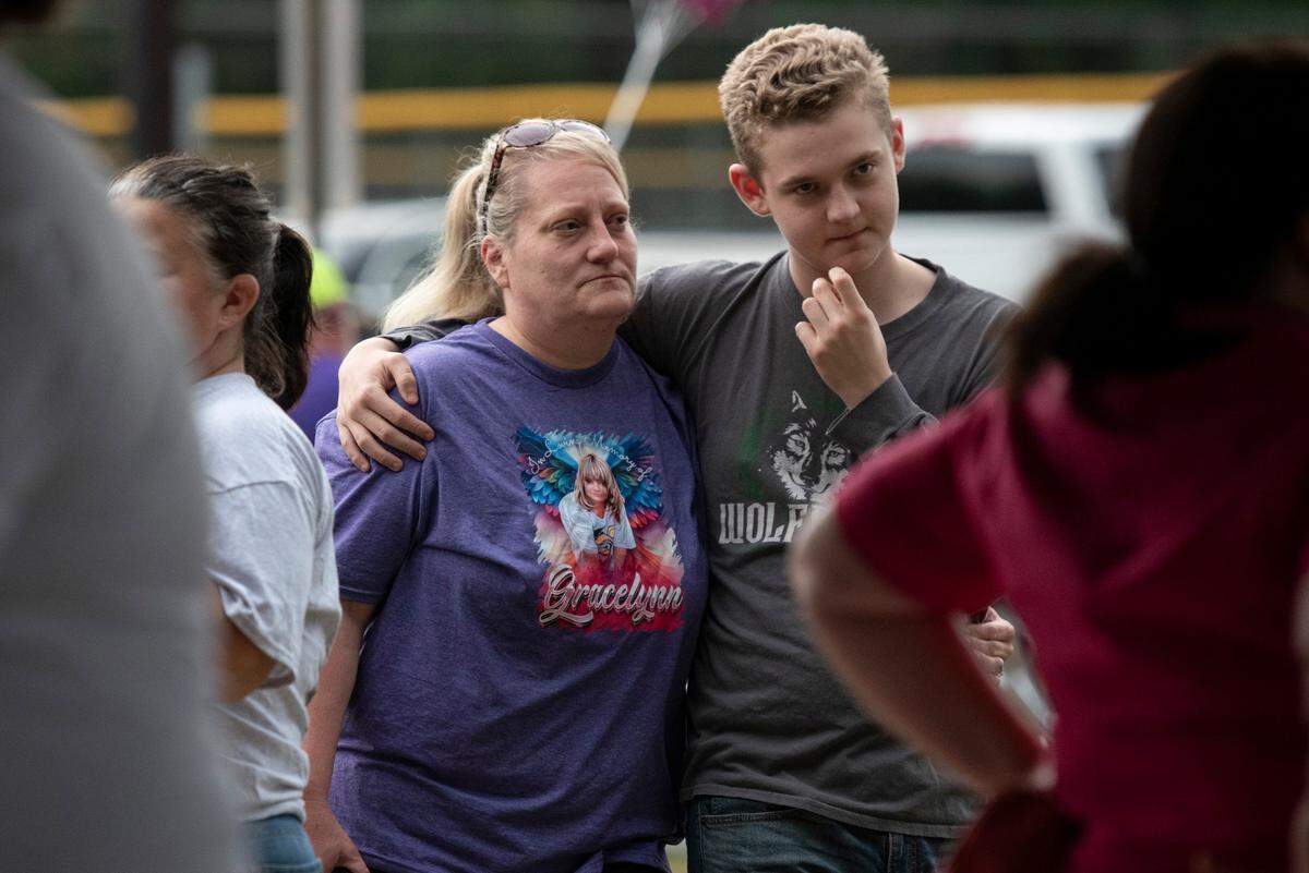 Community members wear t-shirts in honor of Gracelynn Vick at a candlelight vigil remembering her at Saucier Park on Tuesday, April 22, 2025.