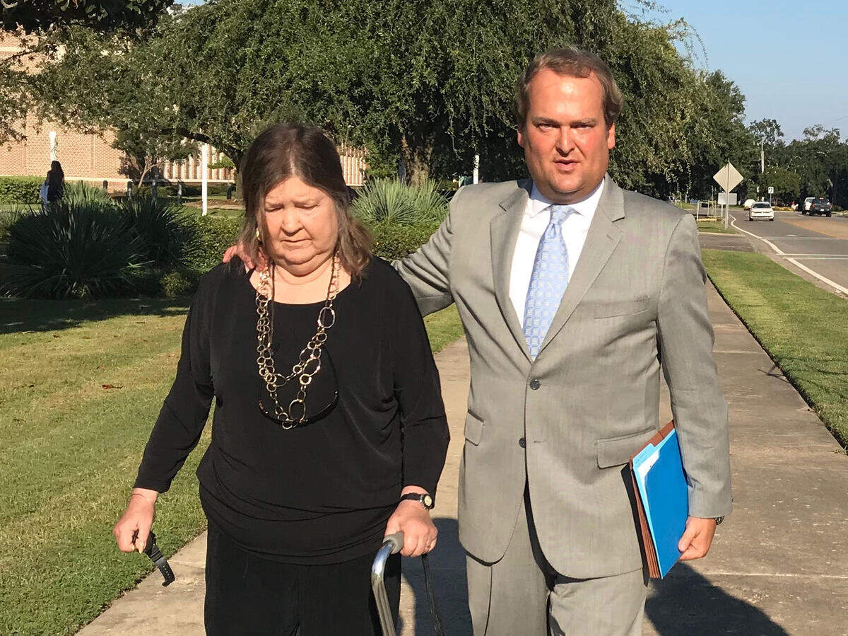 Scott Walker and his mother, Sharon Walker, leave federal court in Gulfport on Wednesday after a hearing that saw his father, Bill Walker, returned to jail for failing to pay restitution.
