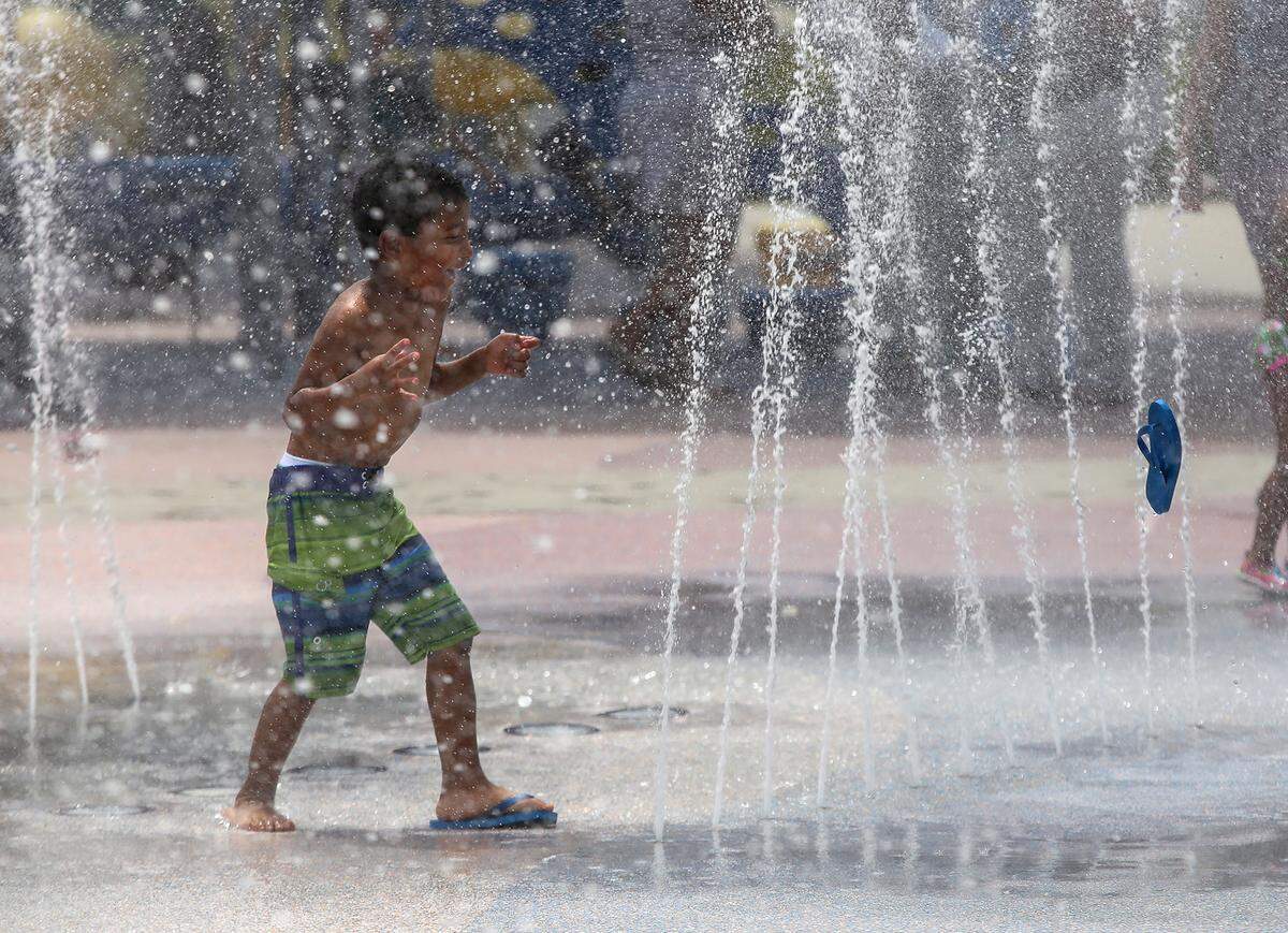 Diondre Daniels, 4, cools off in the splash pad at Point Cadet Plaza on Friday, July 3, 2015, in Biloxi.