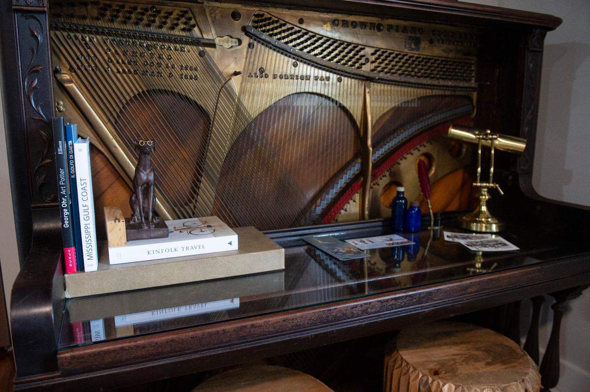 A desk made from an old piano in one of the hotel suites at The Sanctuary in Biloxi on Wednesday, April 16, 2025. When Jason Stearman and Jennifer Miller started renovating the old Trinity Baptist Church, they repurposed the 9 pianos that came with the property into bars and desks.