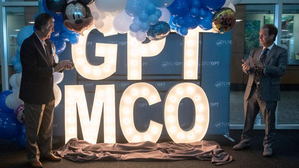 Biloxi Mayor Andrew “FoFo” Gilich and Gulfport Mayor Billy Hewes clap as they reveal the latest offering from the Gulfport-Biloxi International Airport during a press conference at the airport on Tuesday, Oct. 1, 2024. Starting in February, Breeze Airlines will begin flying from Gulfport to Orlando.