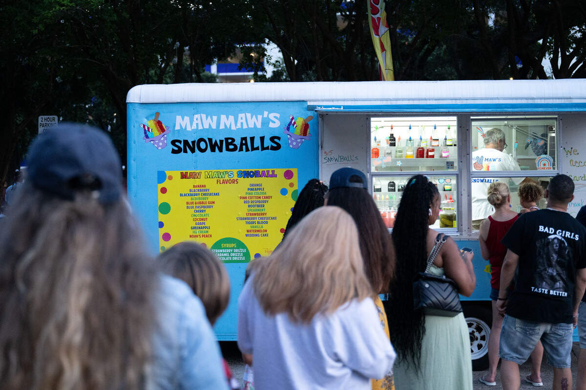 People wait to order snowballs from Maw Maw’s Snowballs during the Fourth of July event at the Biloxi Town Green on Saturday, July 4, 2026.