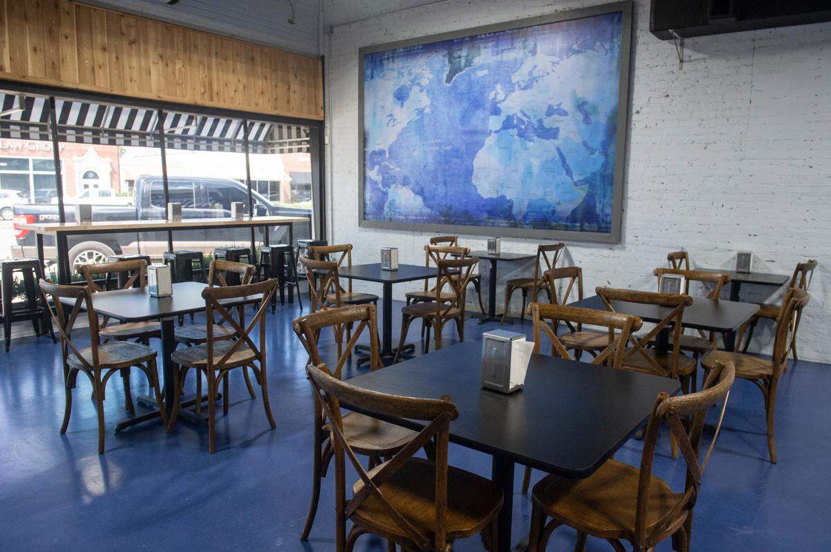 The dining area at Tavi’s Salumeria in Gulfport has a map that will show where in Europe the ingredients came from and their destination in South Mississippi.