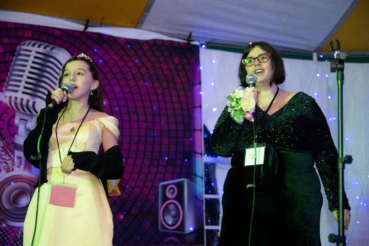 Courtnie Allen, right, sings “Scars to your Beautiful” at karaoke during Night to Shine at Woolmarket Baptist Church on Friday, Feb. 13, 2026.
