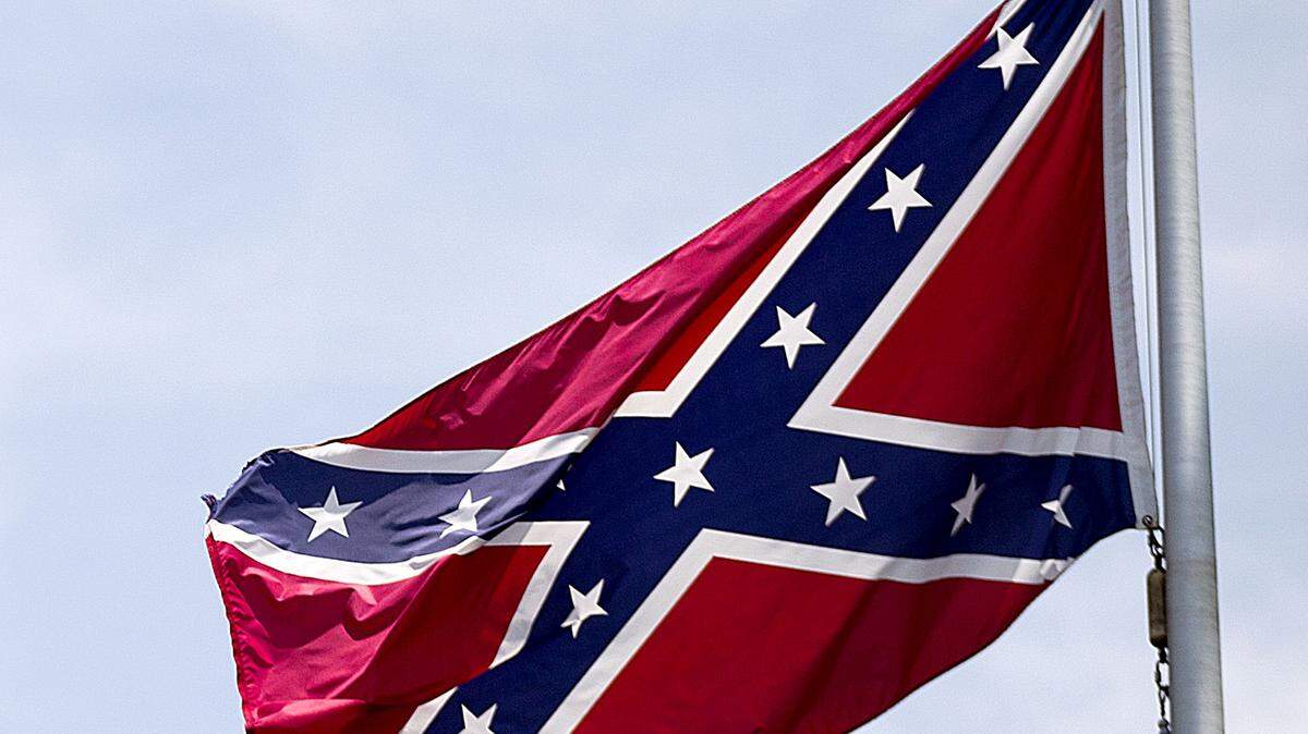 In this June 30, 2015 photo, a Confederate flag flies at the base of Stone Mountain in Stone Mountain, Ga. (AP Photo/David Goldman)