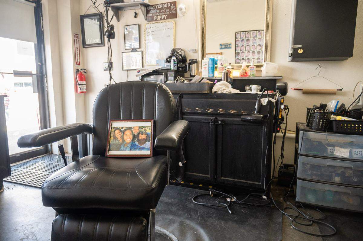 A family photo sits in Howard Picken’s former barber chair. Pickens, a 63 year old man of Waveland, was the first Mississippian to die of COVID-19 complications.