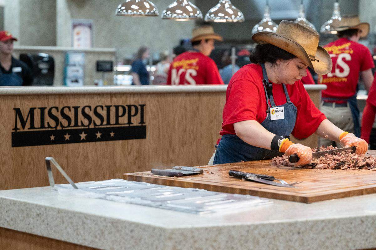 Workers chop brisket during opening day of Buc-ee’s first Mississippi location in Harrison County on Monday, June 9, 2025.
