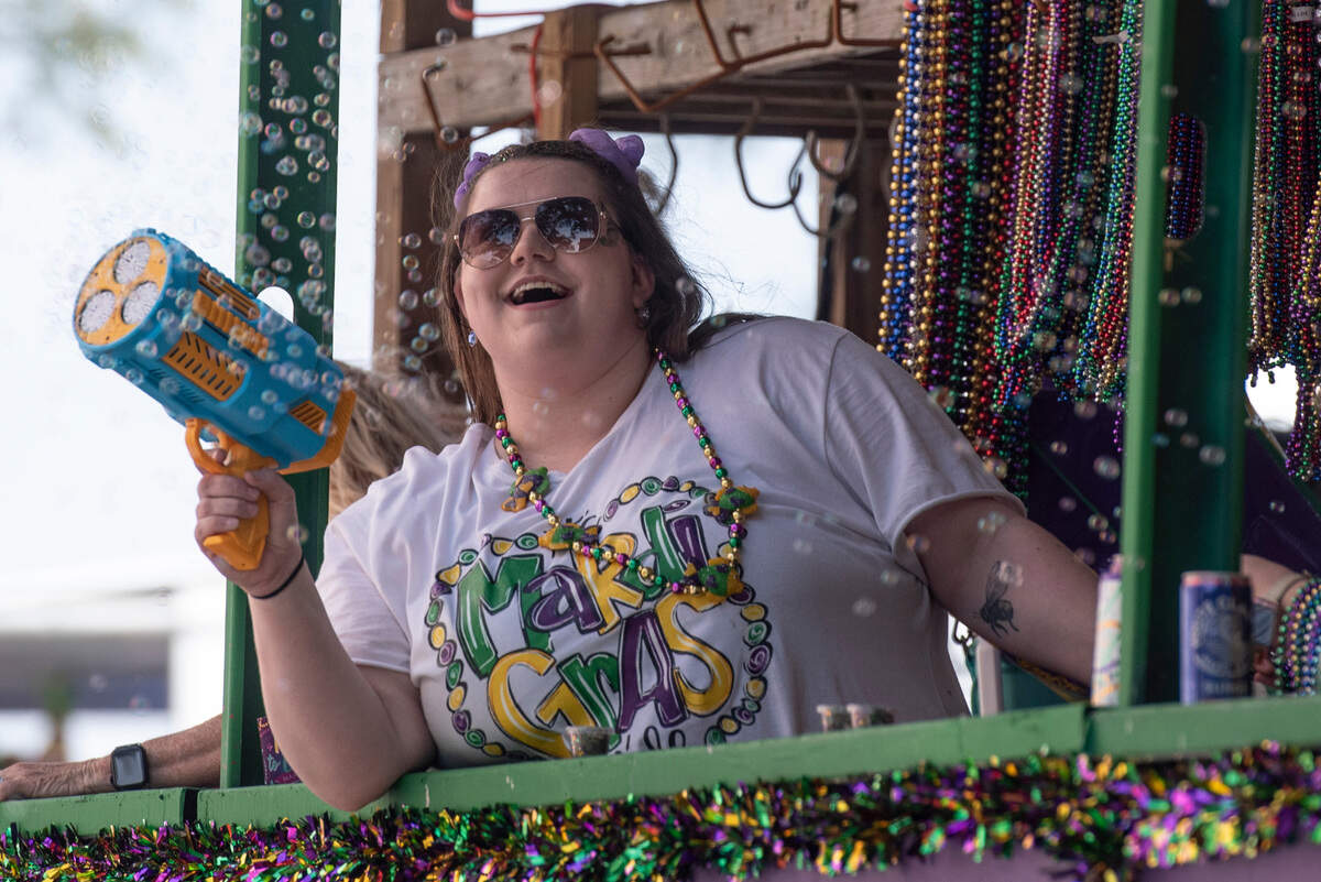 A float rider shoots a bubble gun during the Ocean Springs Elks Club Mardi Gras Parade in Ocean Springs on Saturday, Feb. 15, 2025.