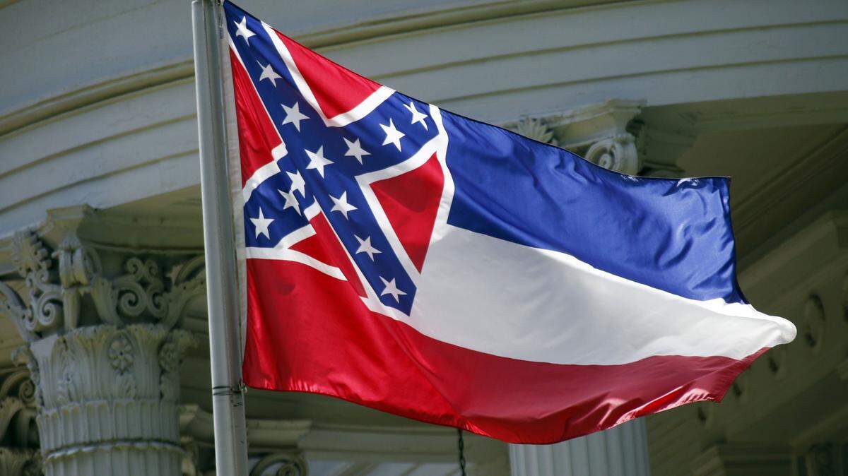The Mississippi state flag is unfurled against the front of the Governor's Mansion in Jackson in 2015. 