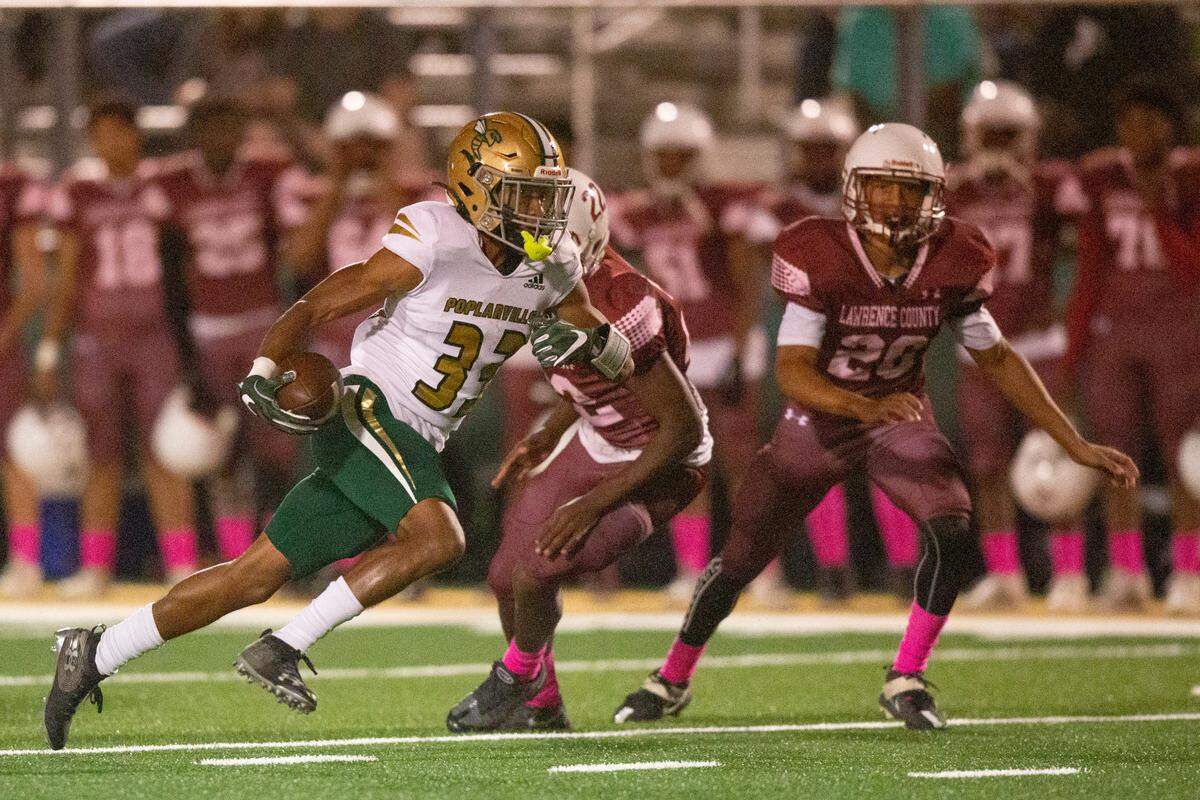 Poplarville’s Benny Jarvis runs the ball down the field for a touchdown during a game against Lawrence County at Poplarville High School in Poplarville on Friday, Oct. 7, 2022.