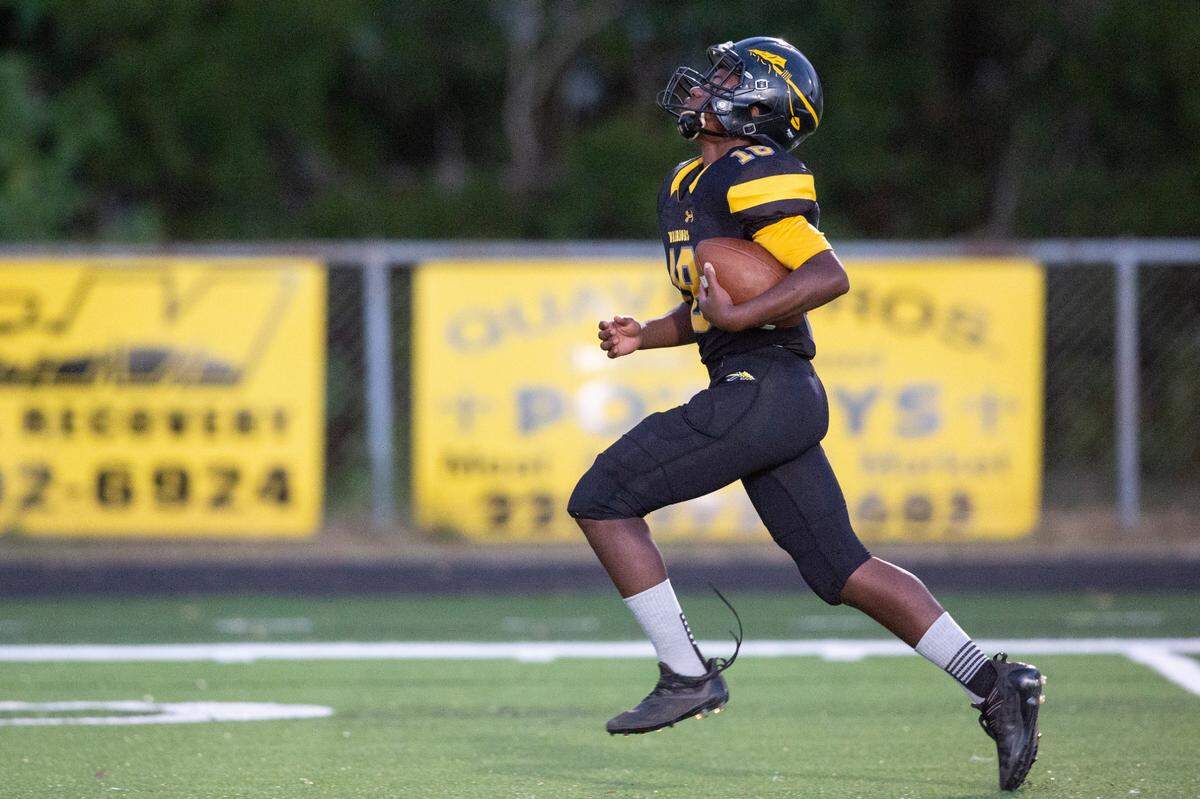 Tyler Hunter, the student manager for D’Iberville’s JV football team, runs the ball down the field during a game against St. Martin at Warrior Stadium in D’Iberville on Monday, Oct. 9, 2023. Hunter, who has an intellectual disability, played for two of the game’s plays, scoring two touchdowns.