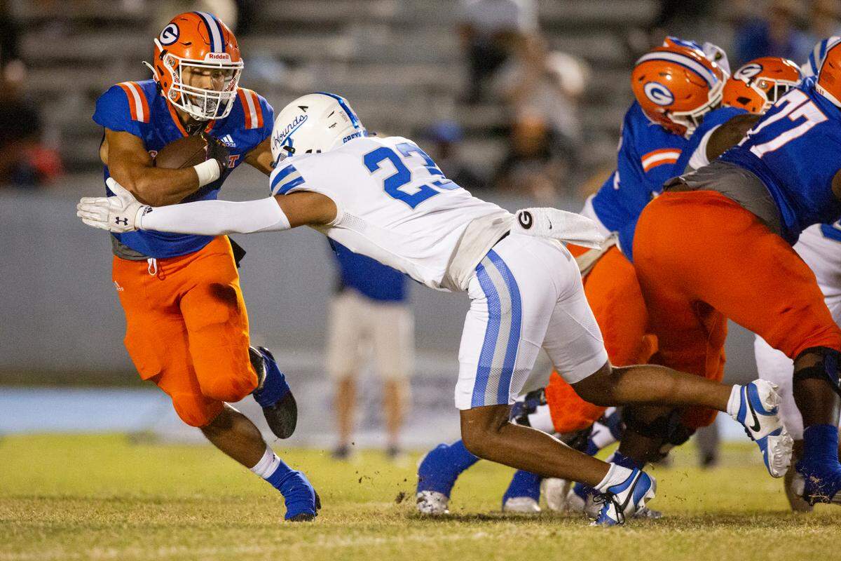 Ocean Springs’ Eric Moore Jr tackles Gulfport’s Cooper Crosby during a game against Gulfport at Milner Stadium in Gulfport on Friday, Oct. 27, 2023. Ocean Springs beat Gulfport 30-7.