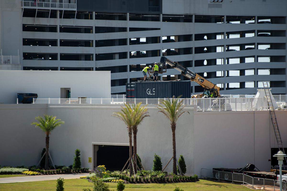 Workers help unload materials for the new amusement park rides at Paradise Pier Fun Park at Margaritaville Resort in Biloxi on Wednesday, June 1, 2022.