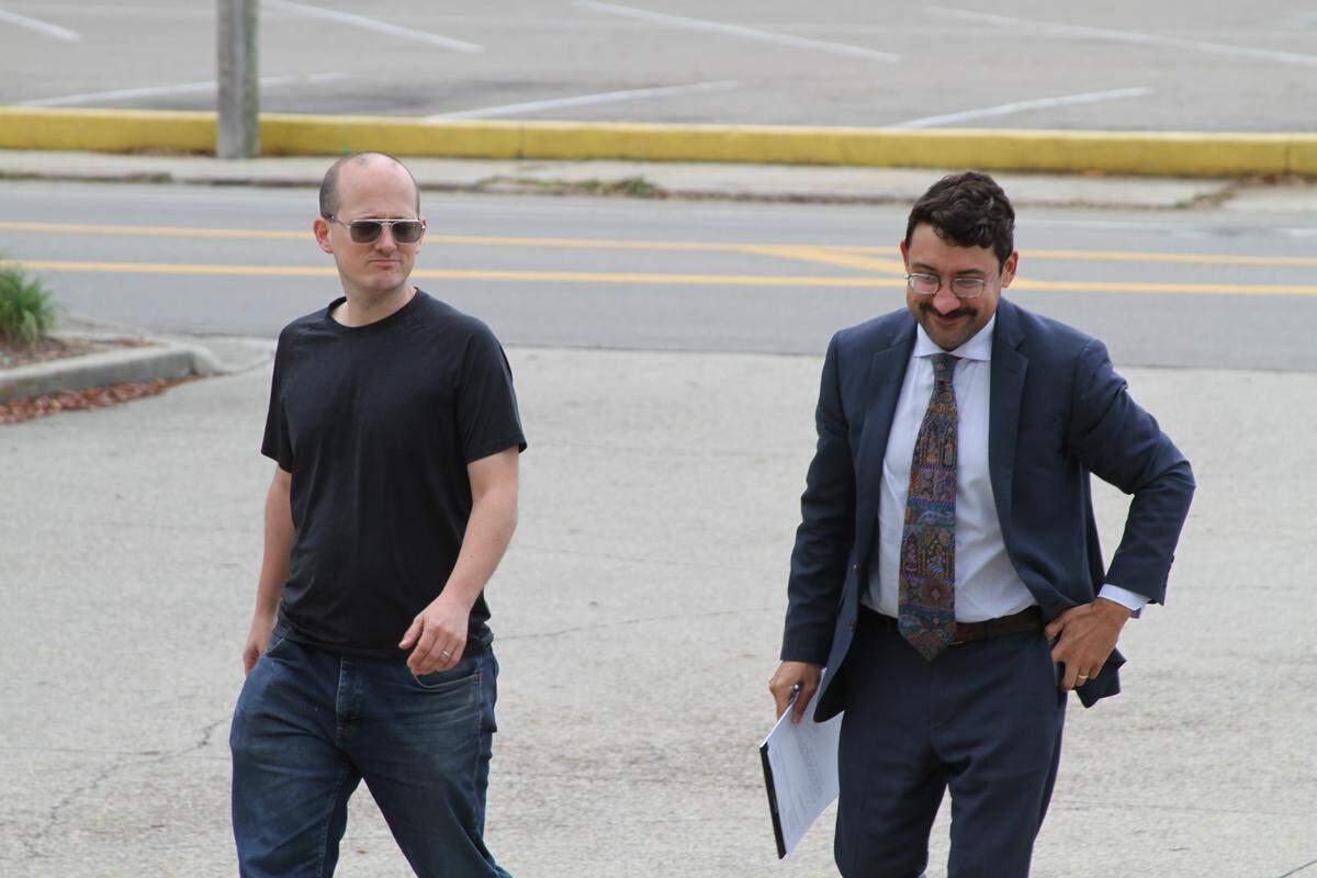 Jarrod Fusco, left, and his attorney Arman Miri of Hattiesburg step into the Biloxi Public Safety Center to find out why Fusco has been charged with the misdemeanor crime of obscene electronic communication.