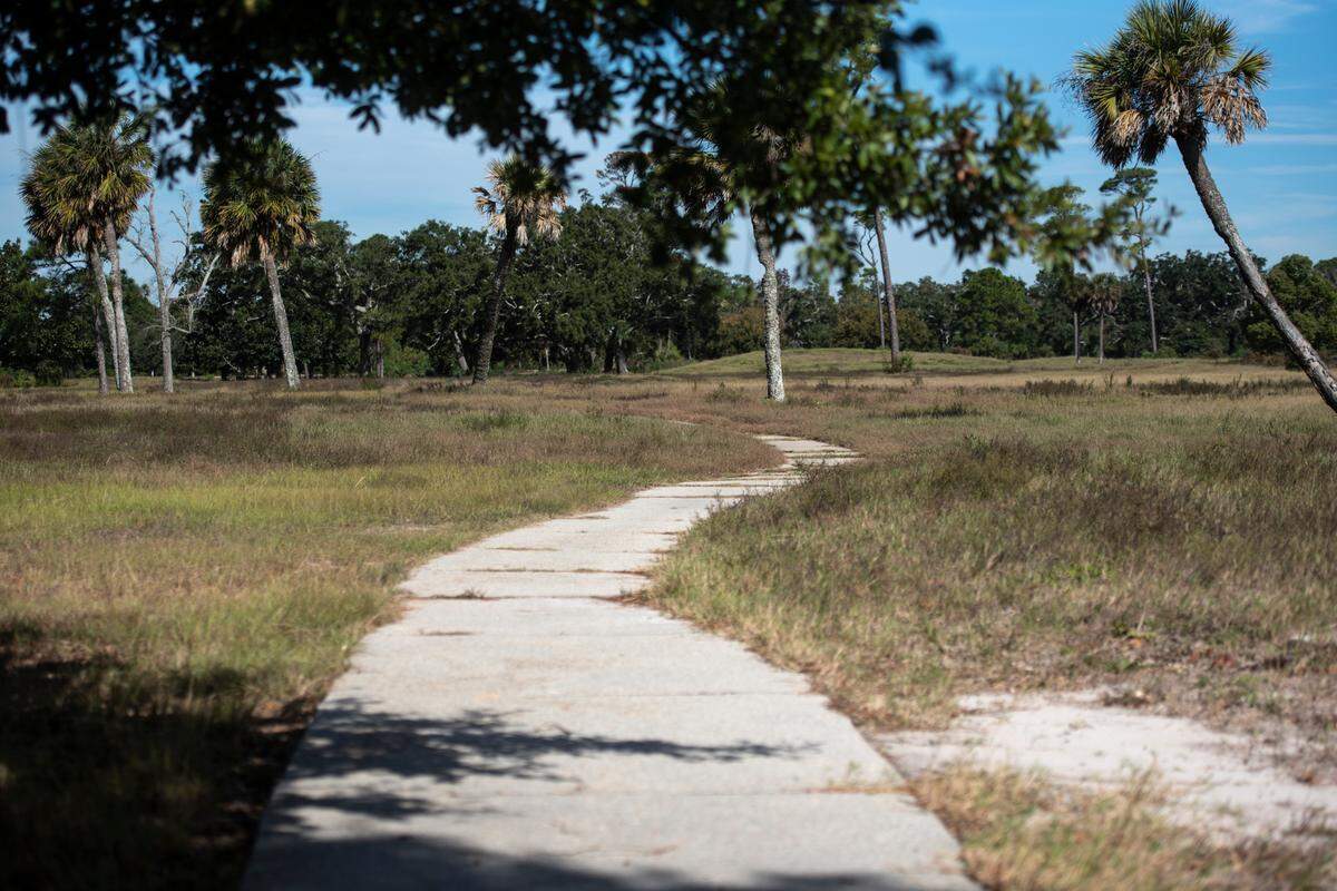 A former cart path weaves through the overgrown fairways of Great Southern Golf Club on Wednesday, Nov. 9, 2022. The club, which closed in May, is supposed to be developed into housing developments but neighbors are concerned about the environmental impact.
