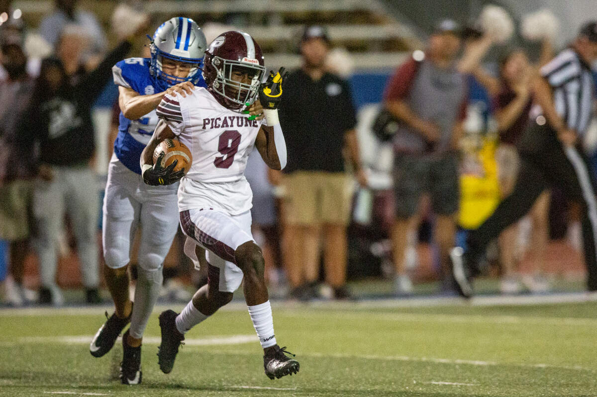 Picayune’s Xavier Dennis runs the ball during a game between Picayune and Ocean Springs at Greyhound Stadium in Ocean Springs on Friday, Sept. 27, 2024.