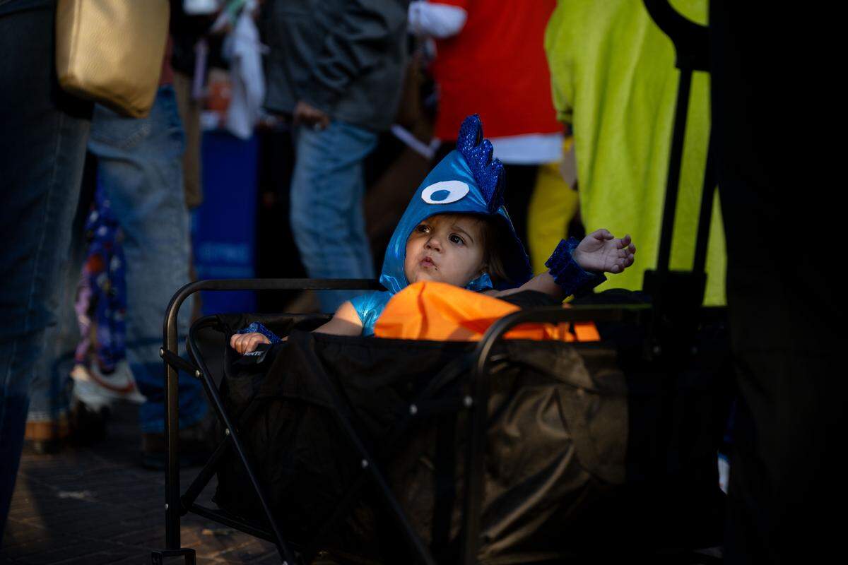 Ruth Pickich is wheeled around in a cart during Boo On The Rue in Biloxi on Thursday, October 30, 2025.