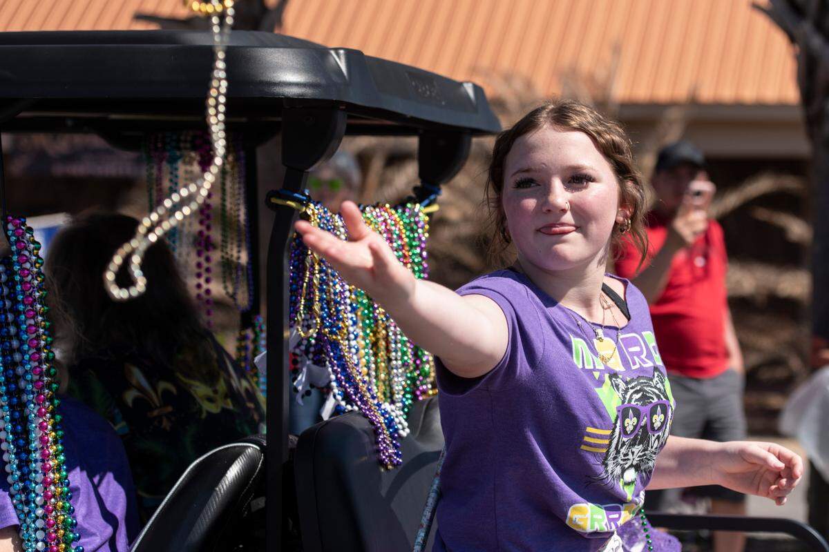 Krewes toss beads and other throws during the Jackson County Carnival Association Mardi Gras parade in Pascagoula on Saturday, March 1, 2025.