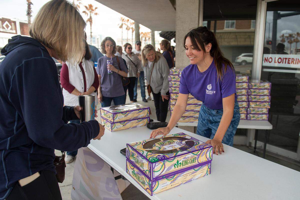 Camren Hensarling sells Loblolly Bakery king cakes during a pop-up sale in Gulfport on Friday, Feb. 7, 2025. The Hattiesburg-based bakery held the pop-up outside what will be The Downtowner, a new restaurant in the same restaurant group as Loblolly.