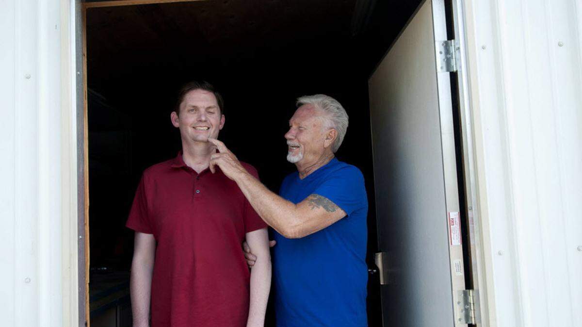 KATHY PLONKA/THE SPOKESMAN/REVIEW/TNSSonny Gilbreath, right, jokes around with his son, Blane, in a shop on their property in Post Falls, Idaho.