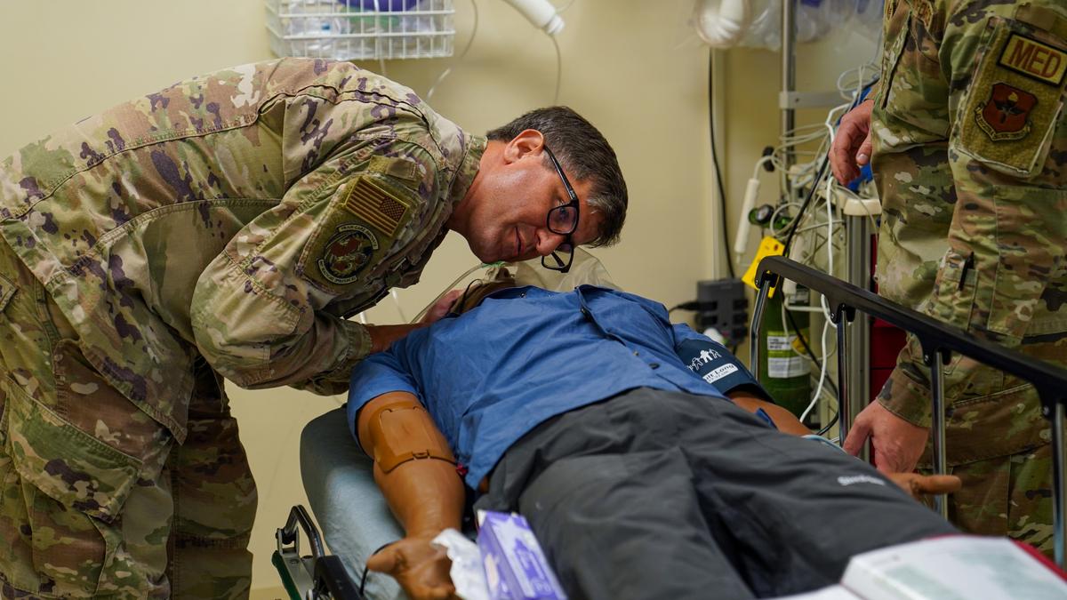 U.S. Air Force Lt. Col. Blake Elkins, 81st Healthcare Operations Squadron, checks a training mannequin for breathing sounds in the Advanced Life Saving Course in the simulation lab at the Keesler Medical Center on Keesler Air Force Base, Mississippi, May 17, 2023. The SIM lab is run by the 81st MDG Education and Training office and is used to train and qualify medical personnel in life-saving skills. The 81st recently ranked as the best hospital on the MS Coast. (U.S. Air Force photo by Airman 1st Class Elizabeth Davis)