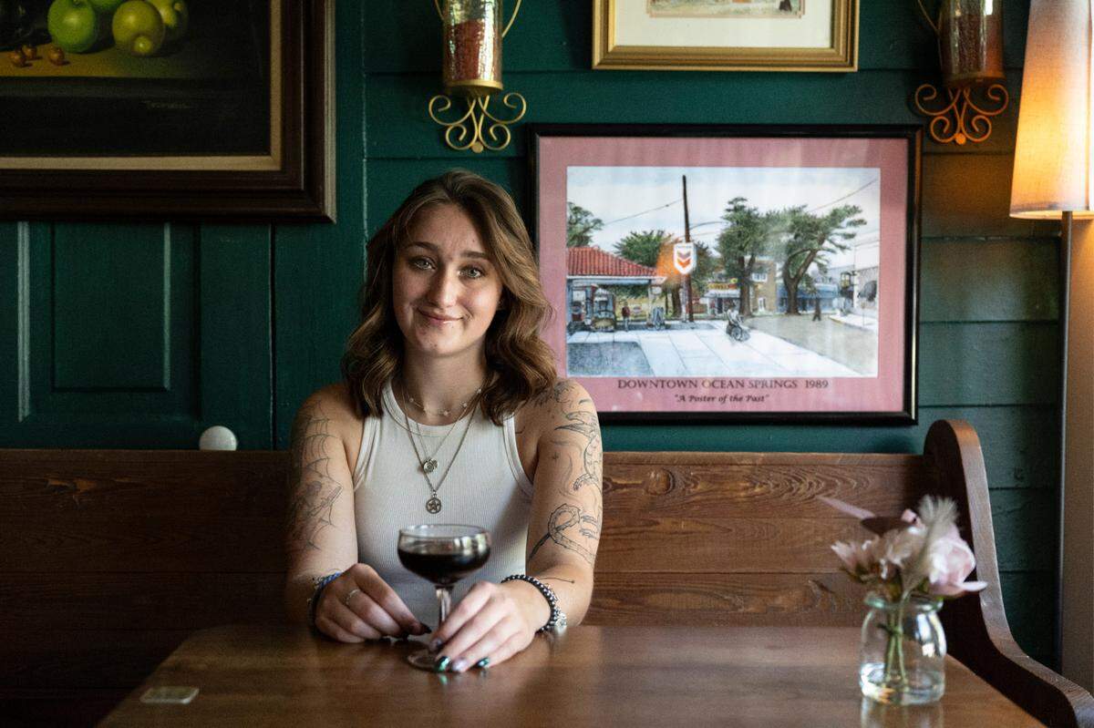 Cassidy Sullivan poses for a portrait at Oak and Vine, a wine bar in Ocean Springs where she works as a bartender, on Thursday, June 26, 2025.