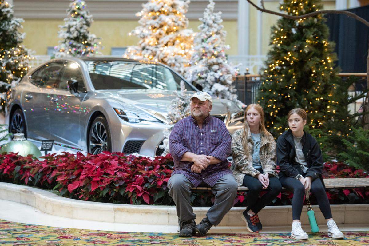 A family sits near a Christmas display inside the lobby at the Beau Rivage Casino in Biloxi on Thursday, Dec. 1, 2022. The Beau Rivage is one of the few casinos on the Coast to allow children.