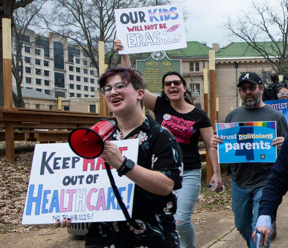 Leviathan Myers-Rowell, 16, from left, of Ocean Springs and his parents Jodi and Thomas Rowell march from the state Capitol toward the governor’s mansion following a rally at the Capitol in support of transgender youth and in opposition to House Bill 1125 in Jackson on Wednesday. HB 1125 prohibits transgender-related healthcare in Mississippi for people under the age of 18. (Barbara Gauntt//The Clarion-Ledger via AP)