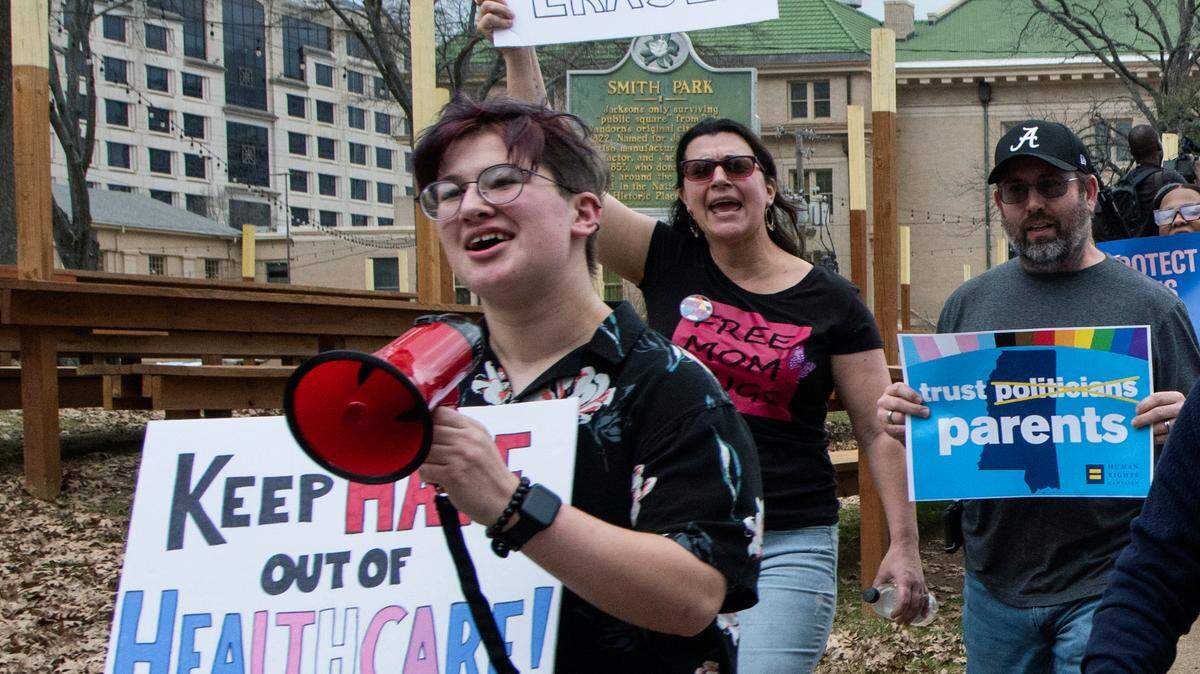 Leviathan Myers-Rowell, 16, from left, of Ocean Springs and his parents Jodi and Thomas Rowell march from the state Capitol toward the governor’s mansion following a rally at the Capitol in support of transgender youth and in opposition to House Bill 1125 in Jackson earlier this month. HB 1125 prohibits transgender-related healthcare in Mississippi for people under the age of 18. (Barbara Gauntt//The Clarion-Ledger via AP))