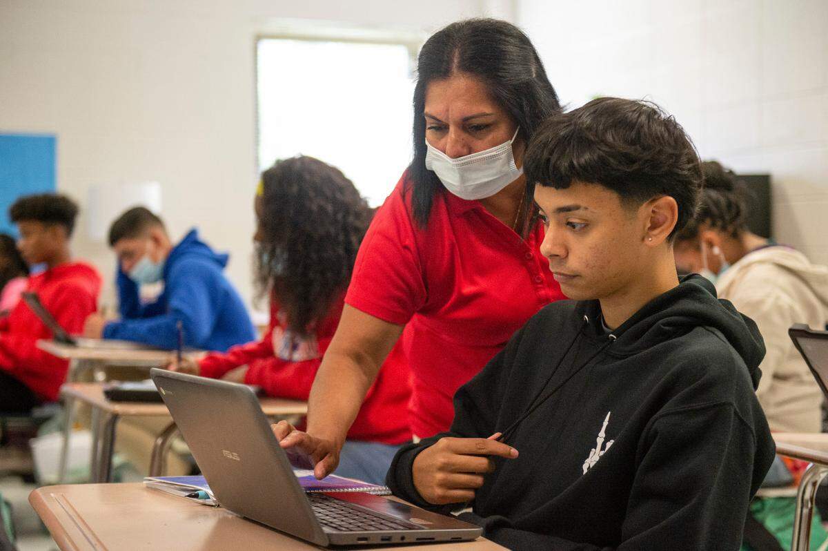 English as a second language teacher Paula Montoya helps student Reinaldo Caraballo with his classwork on Monday, Oct. 25, 2021. Montoya assists many students whose first language is not English.