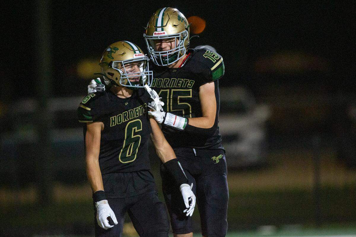 Poplarville’s Zack Case and Jeremiah Moss celebrate after a touchdown during a playoff game between Poplarville and Mendenhall at Poplarville on Friday, Nov. 8, 2024.