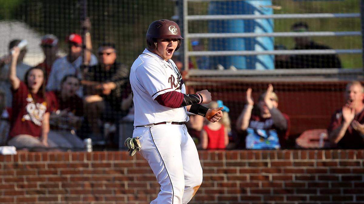 AMANDA McCOY/SUN HERALD 
 George County right fielder Jathan Staton celebrates after safely sliding into home plate during the opening game of the Class 6A South State series on Thursday, May 12, 2016.