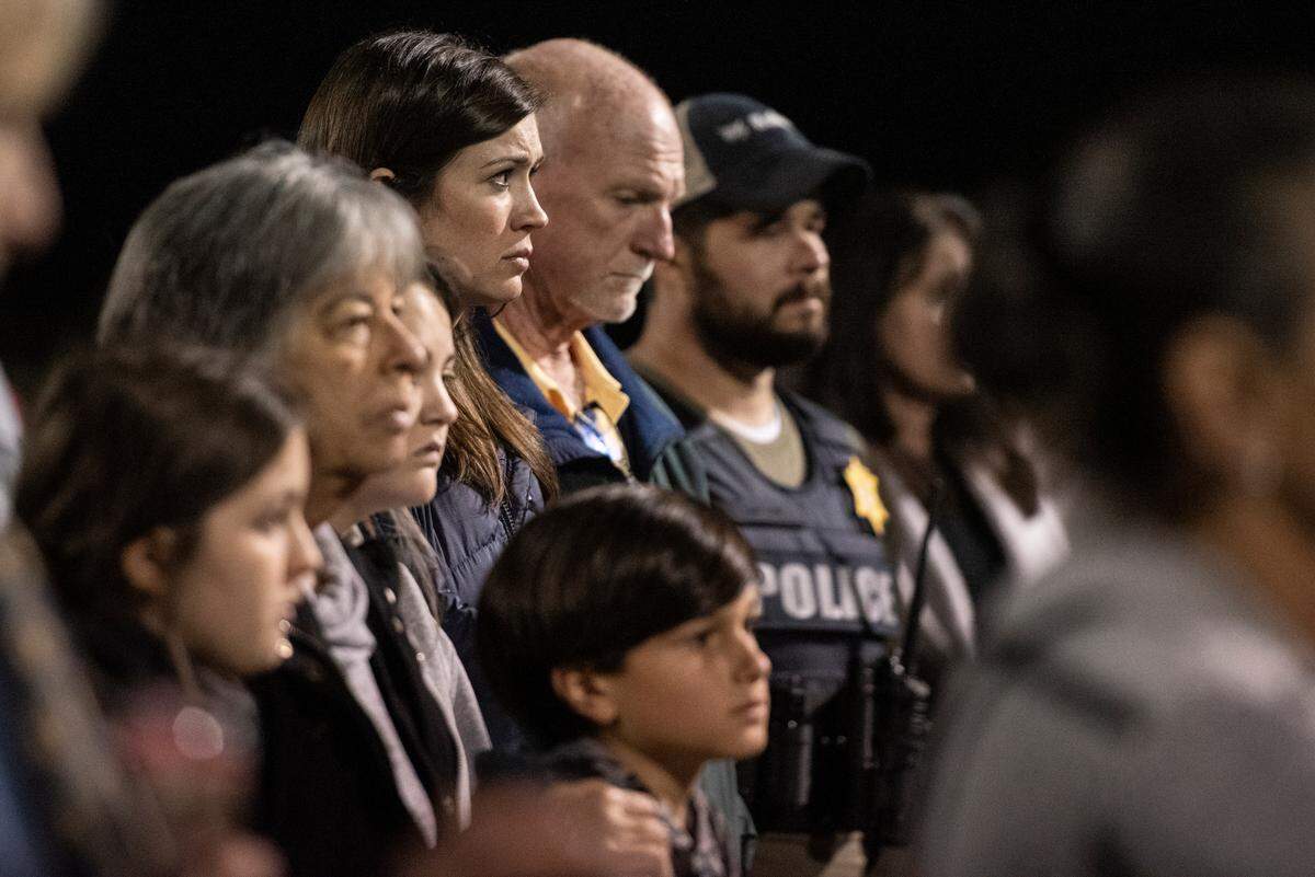 Community members listen during a candlelit vigil for Bay St. Louis Sgt. Steven Robin and officer Branden Estorffe at Tiger Stadium in Bay St. Louis on Thursday, Dec. 15, 2022. Robin and Estorffe were killed on Wednesday when a woman shot both of them.