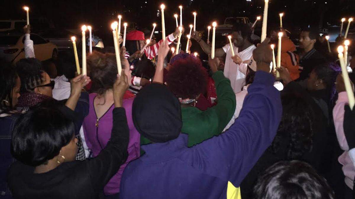 JEFF CLARK/SUN HERALD 
 Friends and family of Isaiah "Winky" Major II and Carlos "Los" Bates attend a vigil Tuesday, Feb. 9, 2016 in Gulfport.