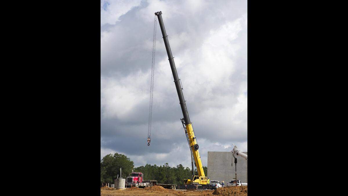 After a few weeks’ absence the crane is back, preparing to lift wall panels in place as the Mississippi Gulf Coast’s first Buc-ee’s continues to take shape west of Gulfport in Harrison County. The travel center is scheduled to open early next year.