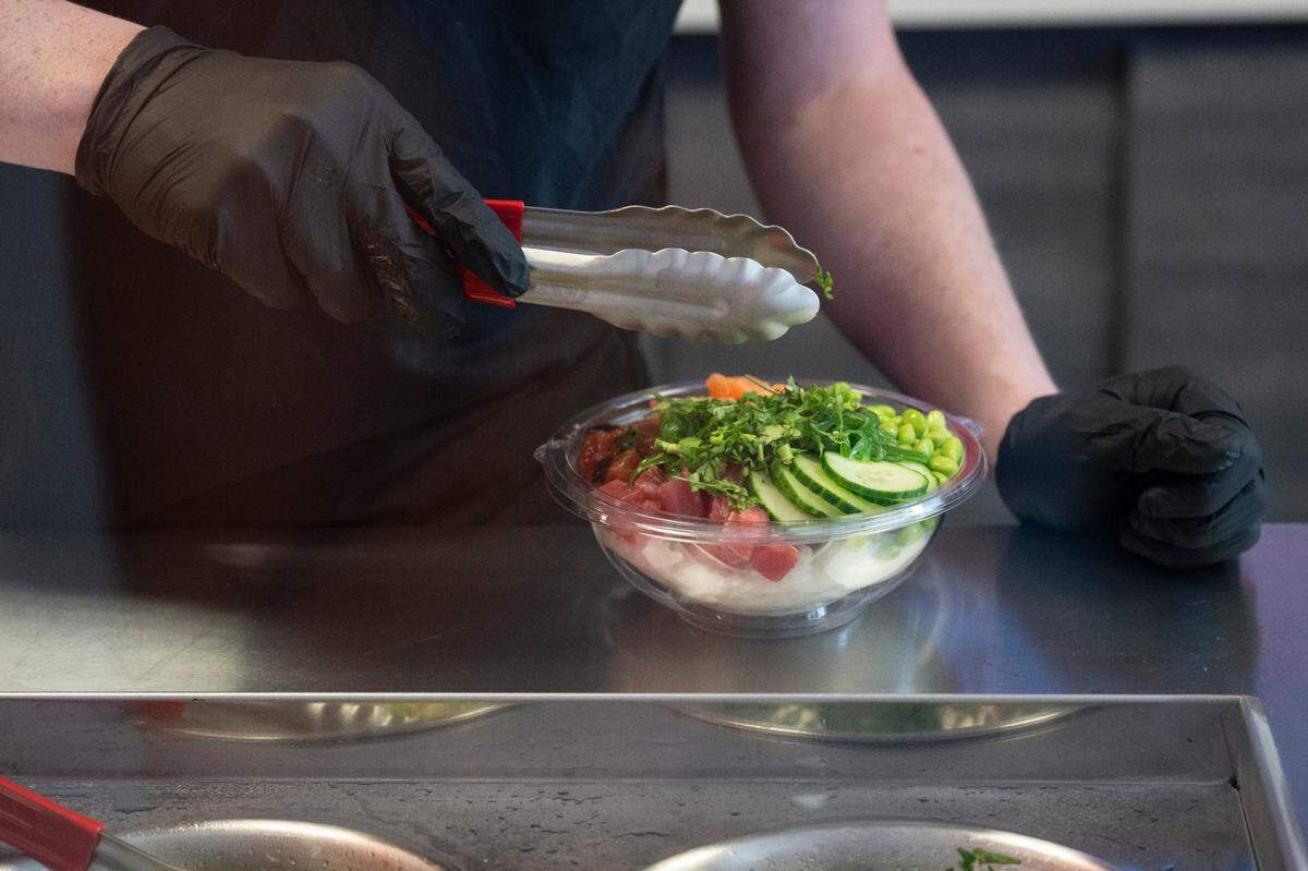 Co-owner Trey McCaige prepares a koibito bowl at Koibito Poke in Gulfport on Thursday, June 5, 2025.