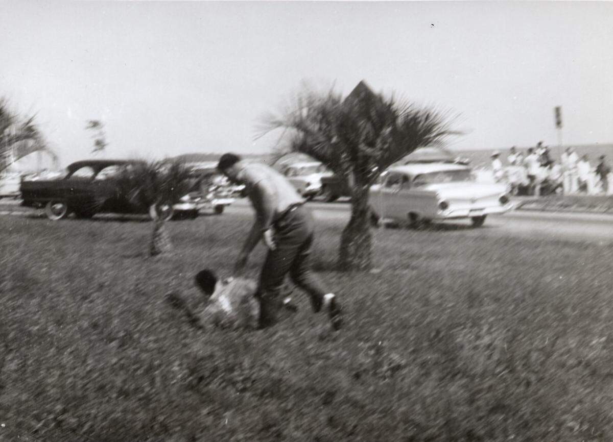 A white man beats a black man April 24, 1960 north of U.S. 90 in Biloxi after a group of black people went swimming in the Mississippi Sound, in an attempt to integrate the public beach. The violence sparked annual wade-in protests at the beach.