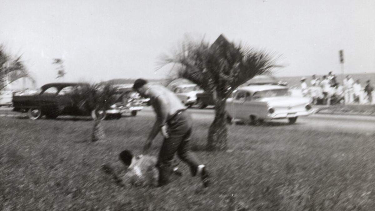 A white man beats a black man April 24, 1960 north of U.S. 90 in Biloxi after a group of black people went swimming in the Mississippi Sound, in an attempt to  integrate the public beach. The violence sparked annual wade-in protests at the beach. 