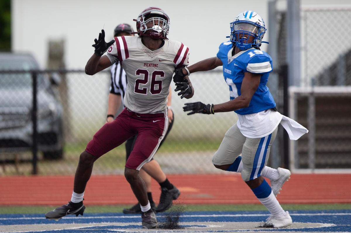Ocean Springs John Paul Coulter, right, looks to catch a pass in the endzone during a spring game at Greyhound Stadium in Ocean Springs on Friday, May 13, 2022.