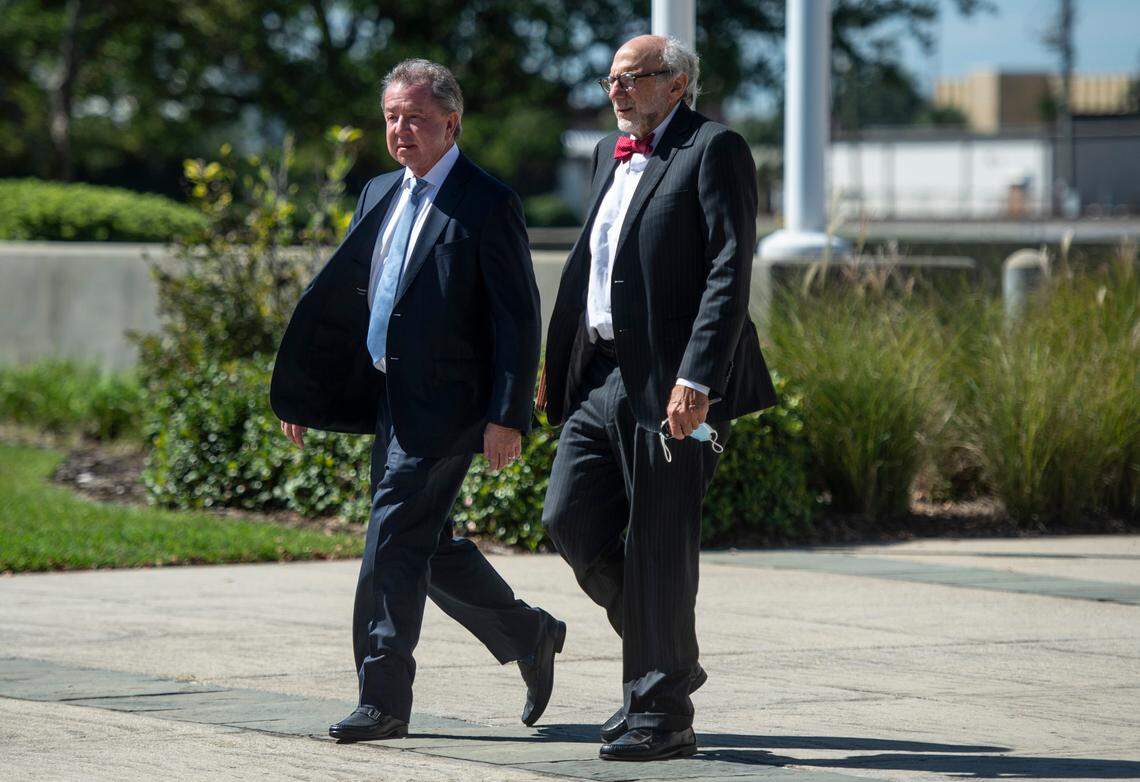 Kenneth Ritchey, left, walks out of the United States District Courthouse in Gulfport following a hearing on his charges of PPE hoarding on Monday, Sept. 27, 2021.