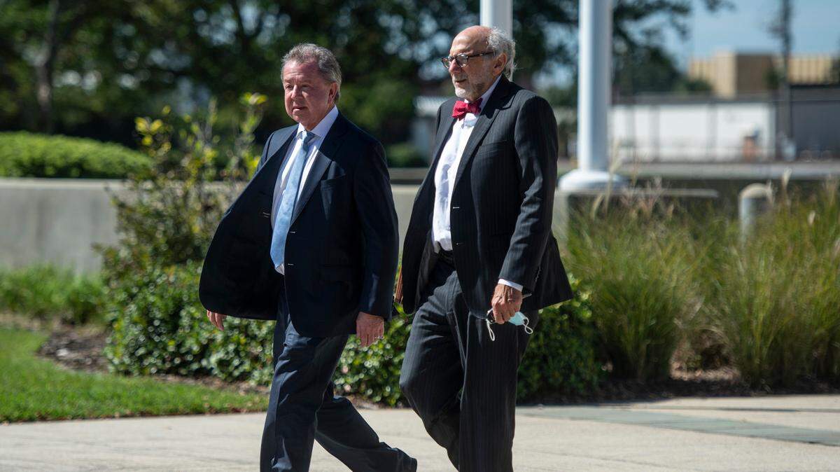 Kenneth Ritchey, left, walks out of the United States District Courthouse in Gulfport following a hearing on his charges of PPE hoarding on Monday, Sept. 27, 2021.
