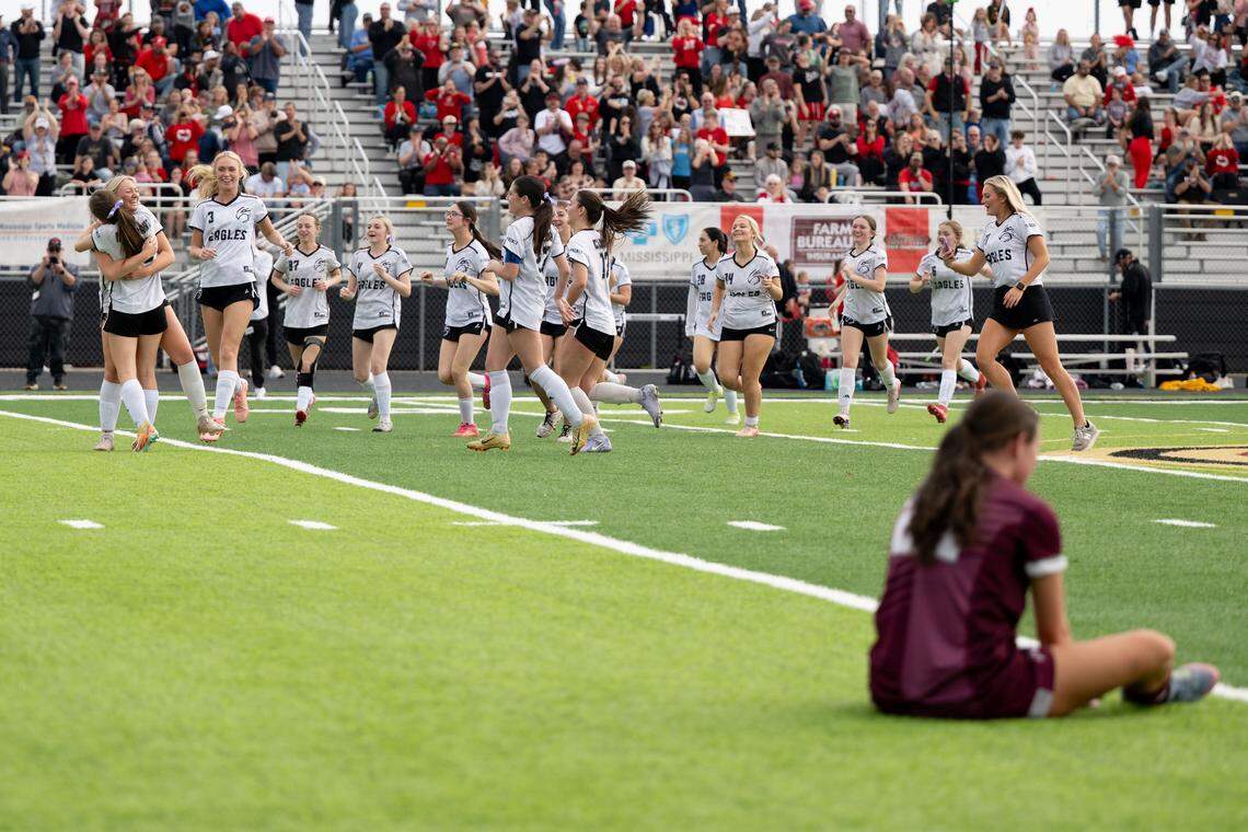 Florence players rush the field to celebrate Saturday.
