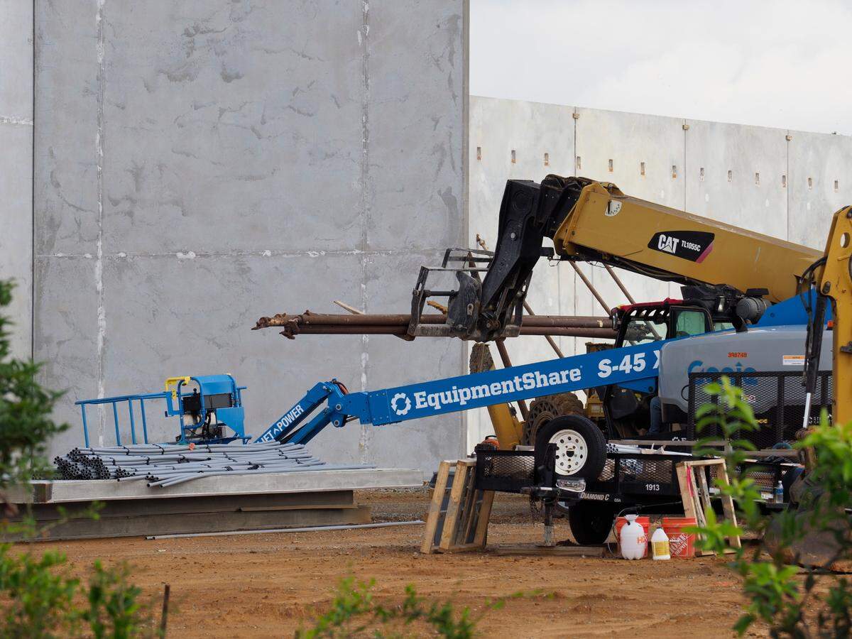 Steel braces are moved into place for additional wall panels to be fitted at the new Buc-ee’s travel center, under construction at Exit 24 of I-10 in Harrison County.