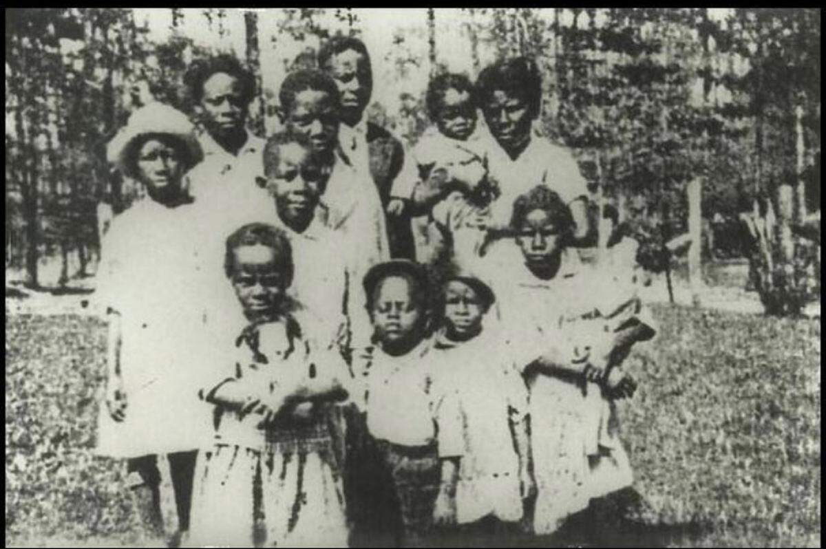 The two smallest children in the front of this photograph, taken around 1928 in Tylertown, Miss., are Melissa Evans’s grandmother and her twin brother. Evans’s grandmother, Doris Tyler Chambers, died in 2019 at the age of 96. The family were sharecroppers in Tylertown before one of Chambers’s sisters got a job on the Coast and eventually bought a home in Gulfport.