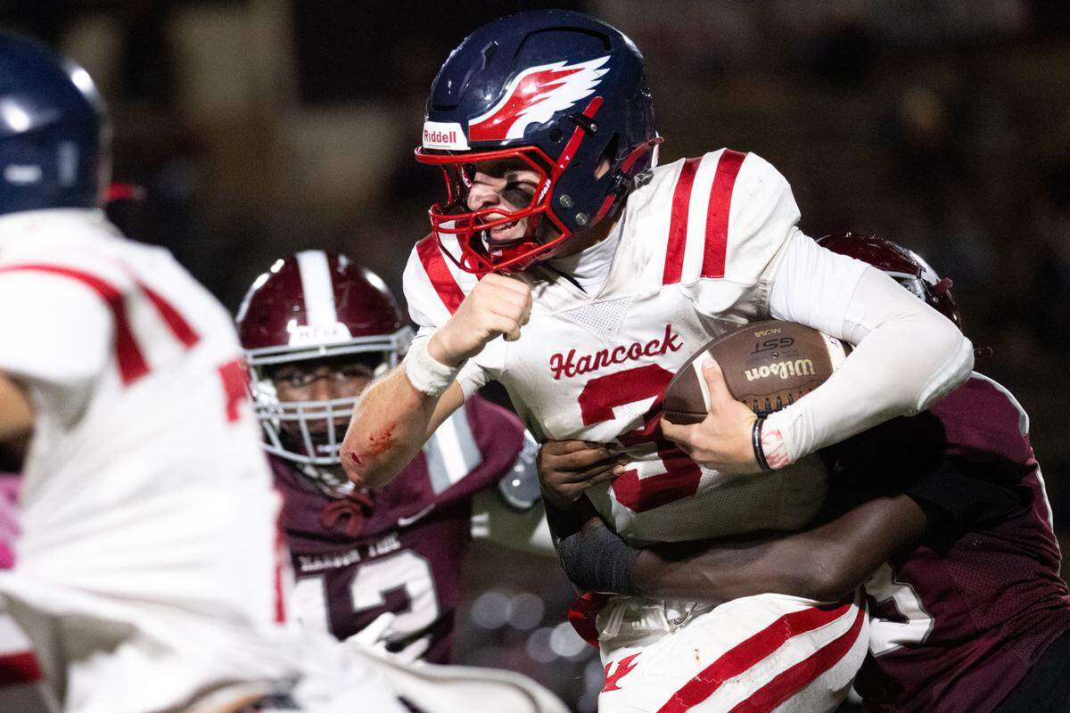Hancock quarterback Kaison Koenenn (3) is tackled as he runs for a first down against Picayune.